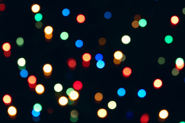 Small bright lights on a dark background - out of focus