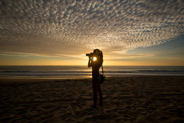 Girl Photographer Taking Pictures With Dslr Camera At Sunset On The Beach