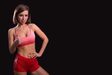 Slim athletic girl shows likes on a black background