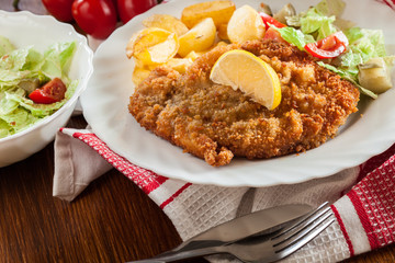 Breaded viennese schnitzel with baked potatoes