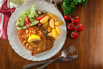 Breaded viennese schnitzel with baked potatoes