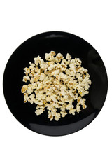 Home-cooked in the microwave the popcorn in a black bowl  isolated on white