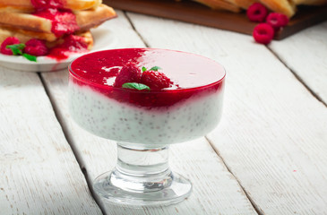 Delicious Italian dessert Panna Cotta with chia seeds and raspberry sauce