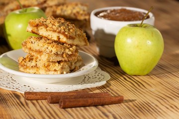 homemade apple pie on a white plate which stands on an old wooden table close-up with a copy space