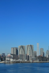Fototapeta na wymiar 晴海ふ頭と建設中のビル(東京オリンピック選手村の建設）をレインボーブリッジから眺める