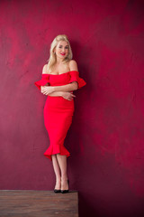 Fototapeta premium Lady in red classical fashionable midi dress, woman elegant fashion , Portrait of elegantly dressed gorgeous romantic woman with red lips