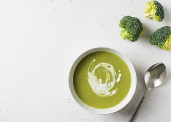 Green vegetable broccoli soup on white background minimalism