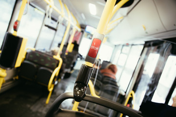 Red stop button in a bus, commuting, public transport