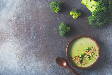 Green vegetable broccoli soup on dark grey background