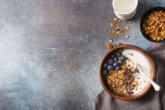 Homemade granola muesli with blueberries ondark grey background breakfast