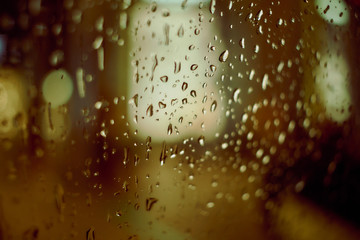 Abstract circular bokeh background of night light with raindrops