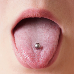 close-up of a female mouth with tongue piercing © Axel Bueckert