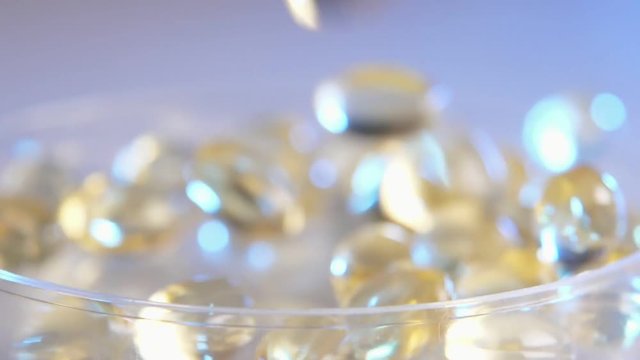 Dazzling crystals sliding in a glass bowl on a table in studion in slo-mo  