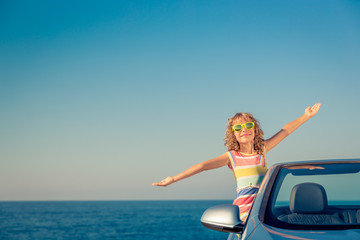 Happy child travel by car