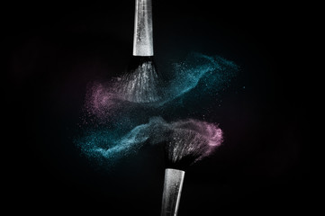 Cosmetic brush with purple and blue ocean cosmetic powder spreading for makeup artist or graphic design in black background