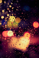 Abstract circular bokeh background of night light with raindrops