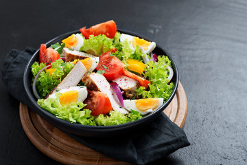 Fresh vegetable salad with chicken breast and eggs.