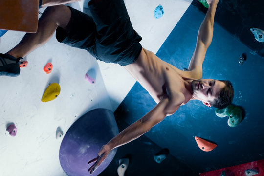 Successful Happy Muscle Healthy Winner Climber Mountaineer Alpinist Man Male Bouldering Training In Climbing Wall. Achieved Top Of Wall In Complex Competition Smiling For Success And Healthy Lifestyle