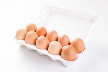 ten brown eggs in white package side view