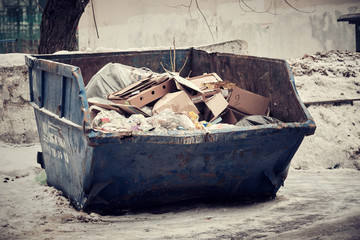 The container with garbage on the street of the city of Moscow
