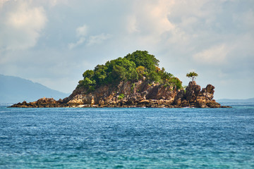 Small stone island with trees in Thailand