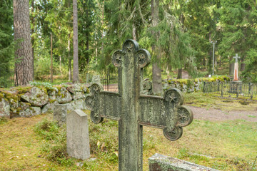 Cross at old beautiful semetery in Finland.