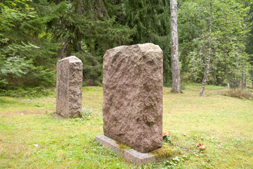 Gravestone at old semetery in Finland with grave crosses and stones.