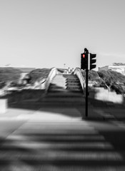 Blurred pedestrian cross with red semaphore