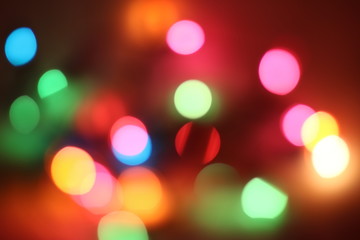 Bokeh light that has many spherical shapes and many colors on the background with blur and darkness.