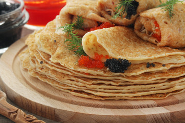 Russian pancakes with red and black caviar