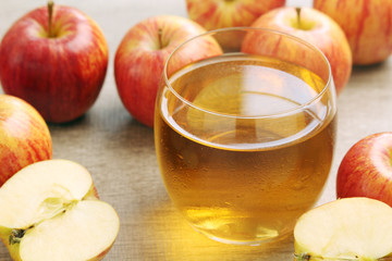 A glass with juice and apples