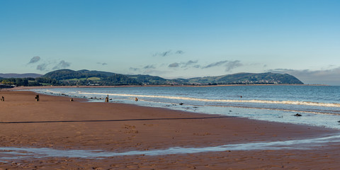 The beach in Blue Anchor, Somerset, England, UK - looking at the Bristol channel and Minehead in the background