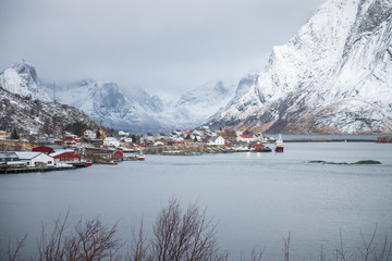 Fishing house village among the snow with mountain view in Lofoten island Reine Norway