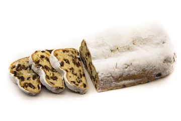 The three slices and the main part of Stollen isolated on a white background. Traditional German Christmas cake with marzipan and dried fruits.