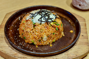 Fried rice with egg yolk and seaweed topping