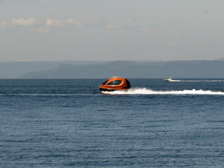 A water taxi races across the waves