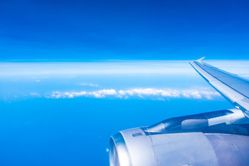 Aerial view of airplane wing with blue sky