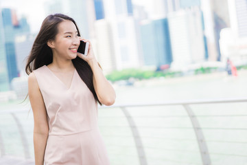 Asian woman using smartphone or mobile phone for talking or text