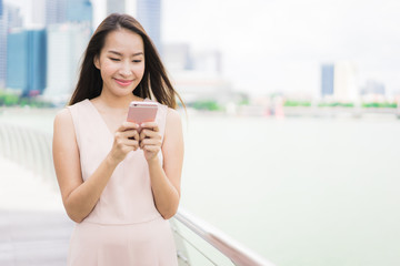 Asian woman using smartphone or mobile phone for talking or text