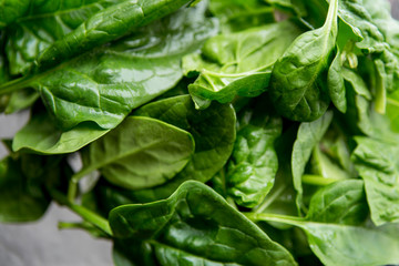 Spinach on white plate on table. Healthy food concept