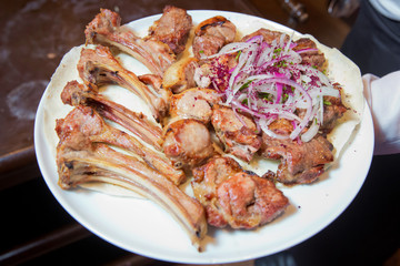 Mutton kebab on plate, close up view . Kebab with onion . Sheep meat Kebab.