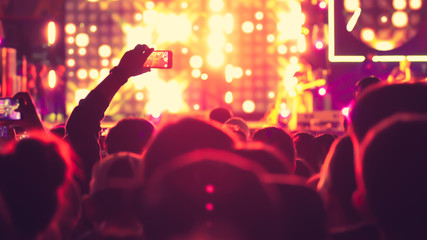 abstract colorful background audience in public concert.