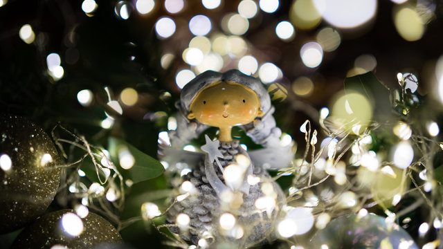 Christmas themed pupet with christmas lights and christmas ball bokeh still life