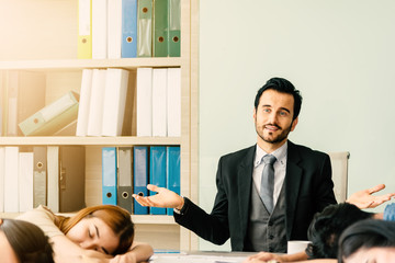 Angry male boss complaining team of business people casual uniform in office while team afraid...