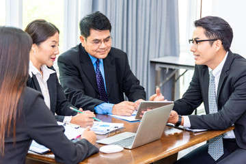 Team of professionals business partners discussing documents and ideas at meeting room.Businessman explaining new business ideas or Entrepreneurs and business people conference in board room.