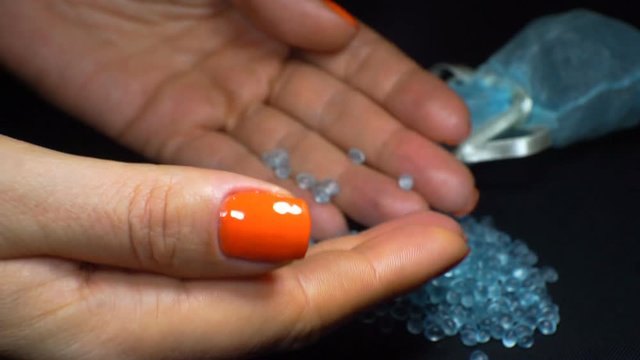 Women's hands hold a blue topaz or a precious stone and check the quality. 1920X1080 Full Hd.