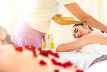 Obraz na płótnie Canvas Young healthy asian woman lying relax in spa salon.Traditional Thai oriental aromatherapy and Massage beauty treatments.Recreation vitality wellness wellbeing resort hotel lifestyle leisure,toned