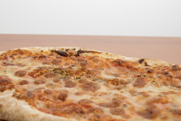 Delicious pizza isolated on a wood table