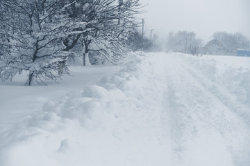 Winter snowfall in the village. Snowy collapse