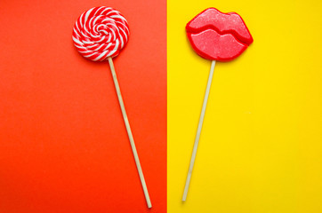 two lollipops on a red and yellow background